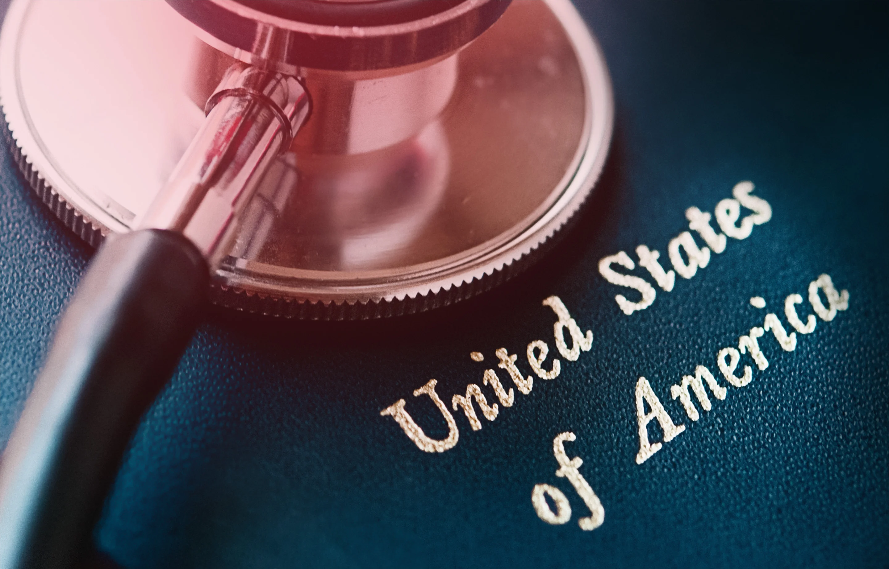 Stethoscope resting on a dark blue book embossed with United States of America, representing VA and HHS federal healthcare contracting opportunities including T4NG2, BARDA BAA, MSPV, and CDC data modernization